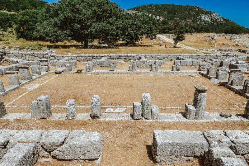 Αρχαία Κασσώπη: Το «Μάτσου Πίτσου» της Ελλάδας: Ερείπια της αρχαίας πόλης που δείχνουν πέτρινα θεμέλια και χαμηλές τοιχοποιίες διατεταγμένες γύρω από ένα κεντρικό τετράγωνο.