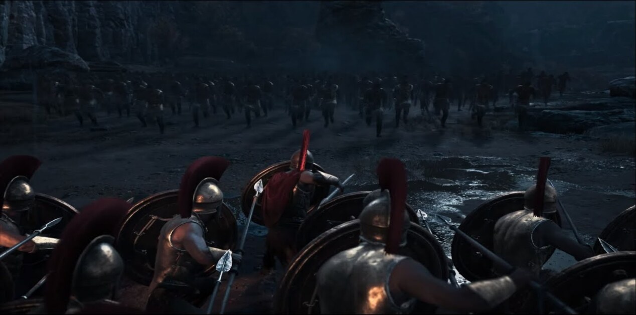 Μια σειρά από Σπαρτιάτες οπλίτες γονατισμένοι, με ασπίδες και ανυψωμένα δόρατα, αντιμετωπίζουν μια ορδή εχθρών που φορτίζει.