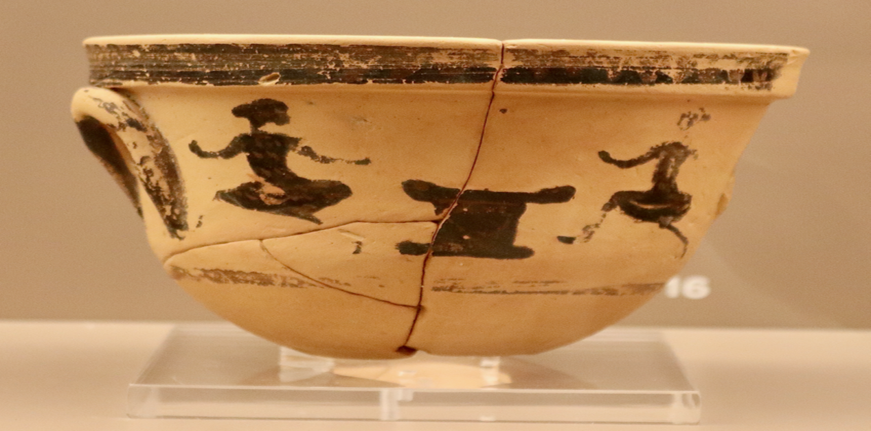 Μελανόμορφος πήλινος κρατηρίσκος που απεικονίζει μικρά κορίτσια να τρέχουν κατά τη διάρκεια τελετουργίας.